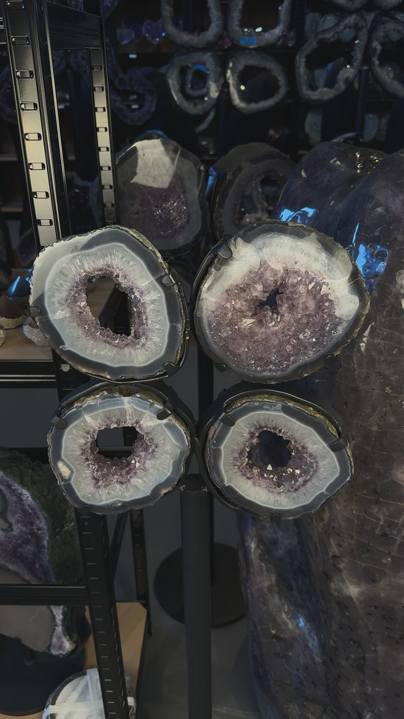 Amethyst Portal Scheiben in Blumenform auf Stahlständer dekorativ angeordnet